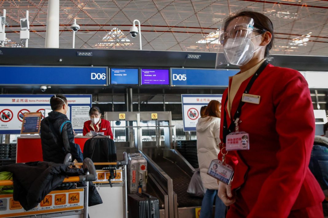 Personal de las líneas aéreas atiende a los pasajeros en el Aeropuerto Internacional de Pekín el 30 de noviembre de 2022. EFE/EPA/MARK R. CRISTINO
